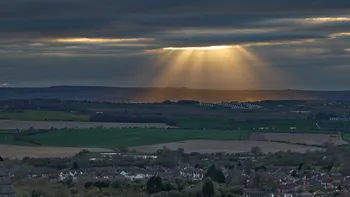 Gods rays on a cloudy spring evening over a solar farm 3.jpg